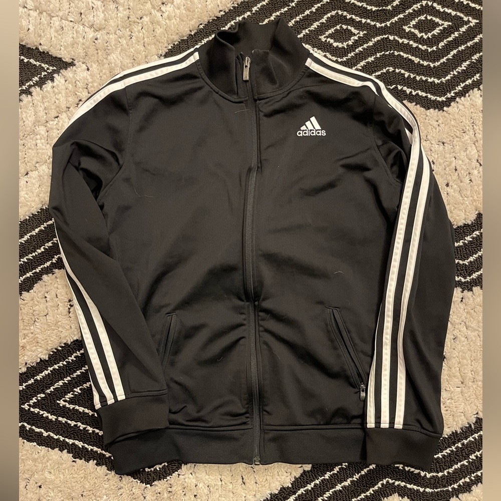 Adidas track jacket fits like a Women’s Small